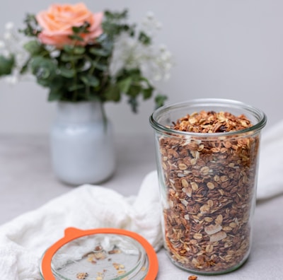 brown and white food in clear glass jar