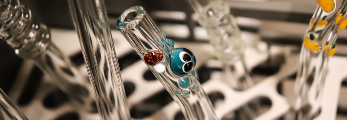 a group of glass tubes with different colored beads on them